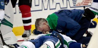 Canucks defenseman Larsen taken off ice on stretcher