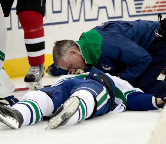 Canucks defenseman Larsen taken off ice on stretcher