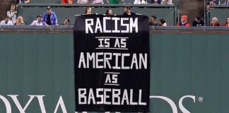 Fans denounce racism with sign above Green Monster