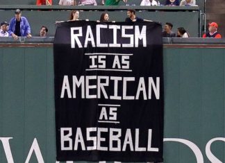 Fans denounce racism with sign above Green Monster